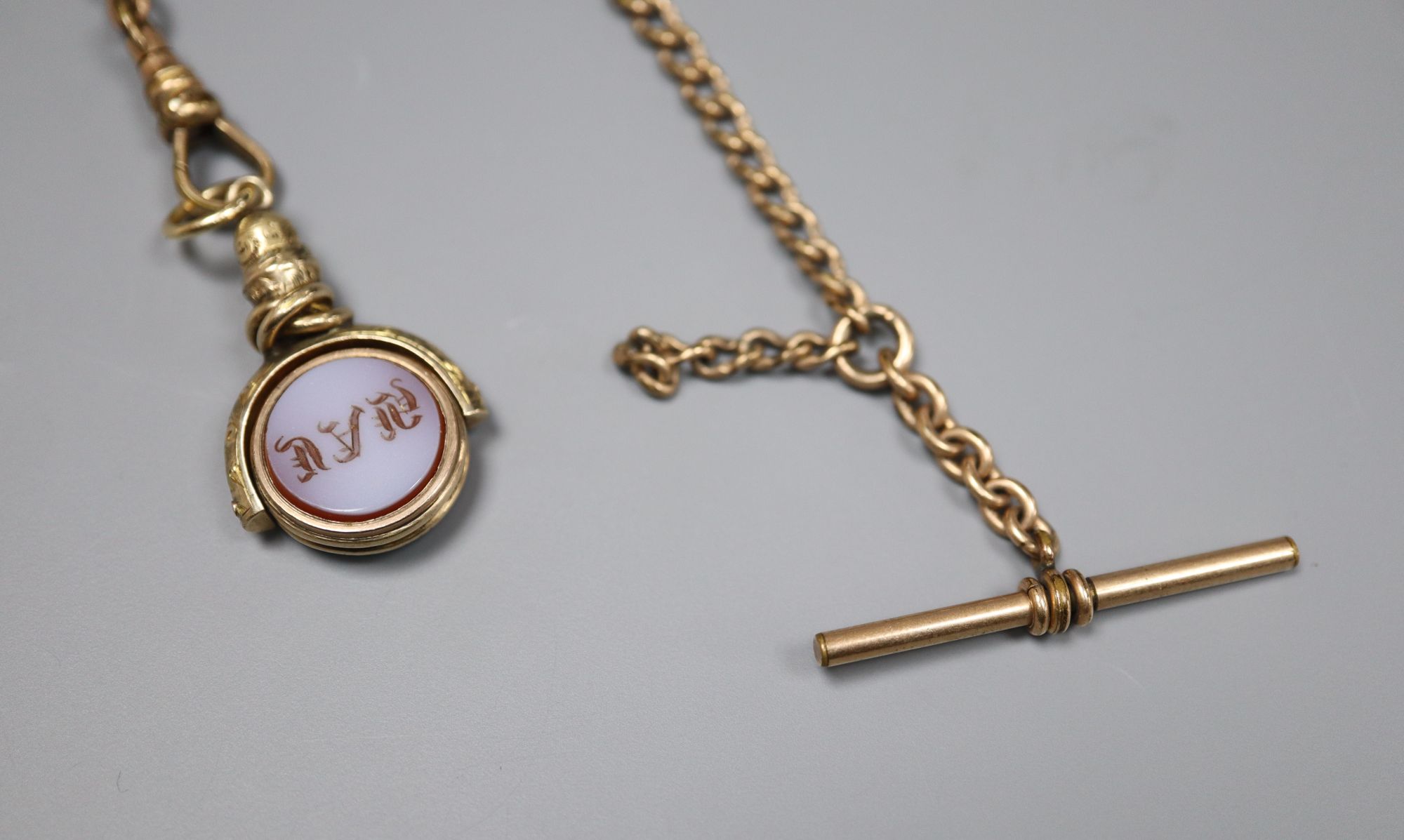 A Victorian yellow metal overlaid, sardonyx and bloodstone set swivelling fob, 30mm, on a gilt metal chain.